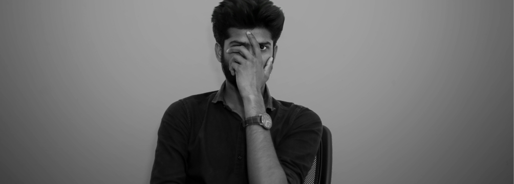 Man frustrated with hand over face